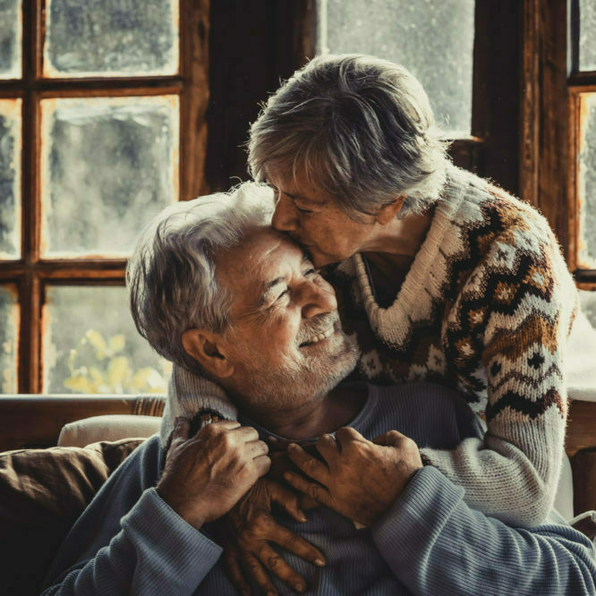 Senior people at home in love kissing and caring each other. Happy relationship mature couple